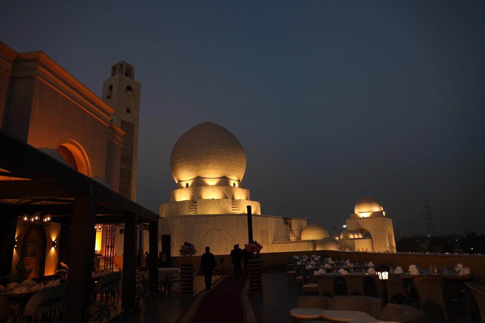 Poet Rooftop Garden at dusk with illuminated white domes — emblematic of Poet Hospitality Group's Lahore experience