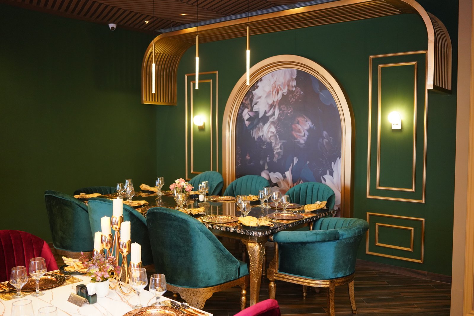 A private emerald-velvet dining room at Poet Mughlai, set for a quiet evening — Poet Hospitality, contact and inquiries